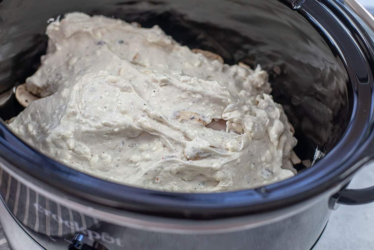 sauce spread over chicken in crockpot.