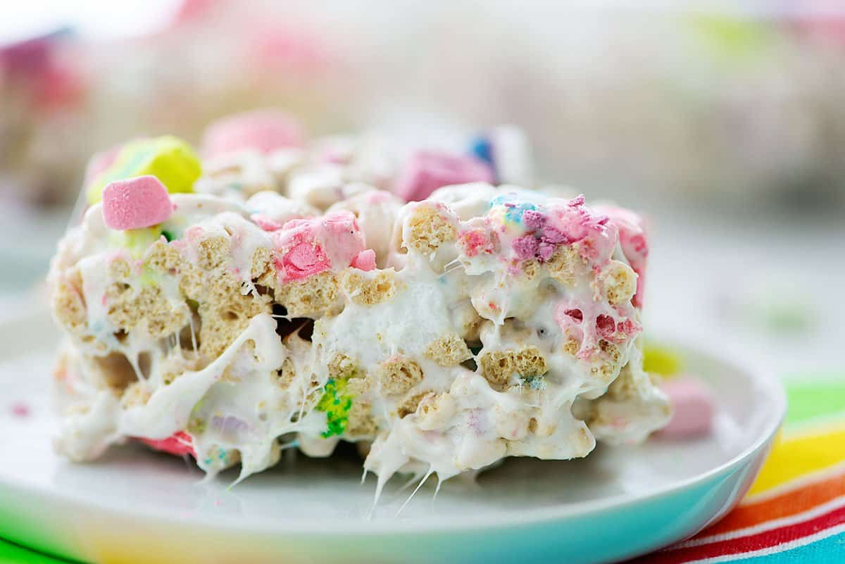Lucky charms rice krispies treats on white plate.