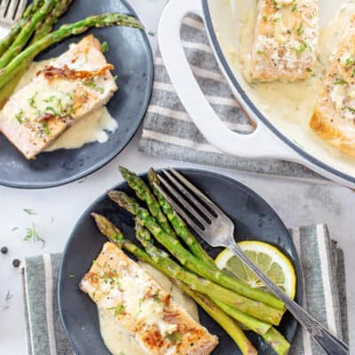 lemon garlic salmon on black plate.