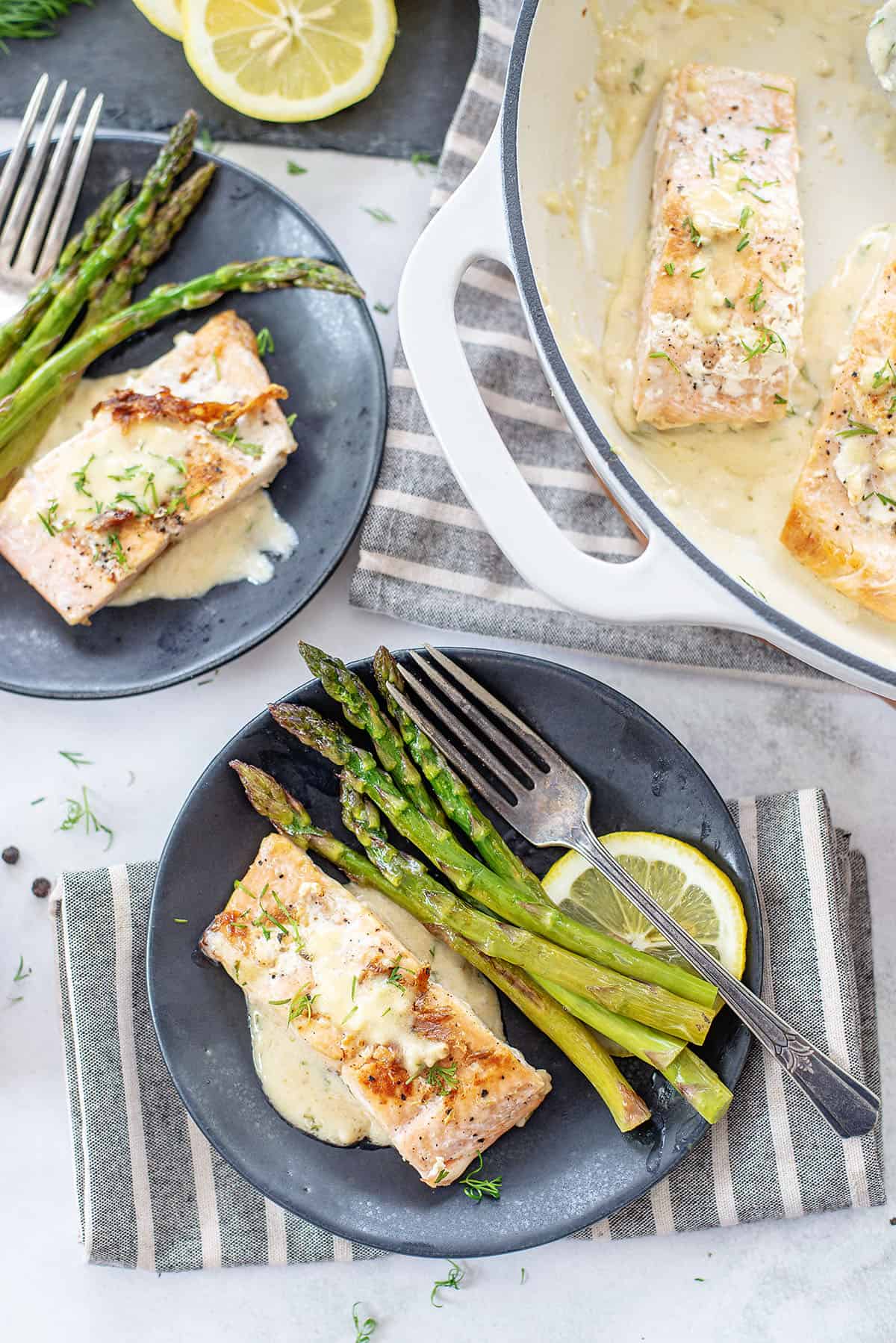 lemon garlic salmon on black plate.