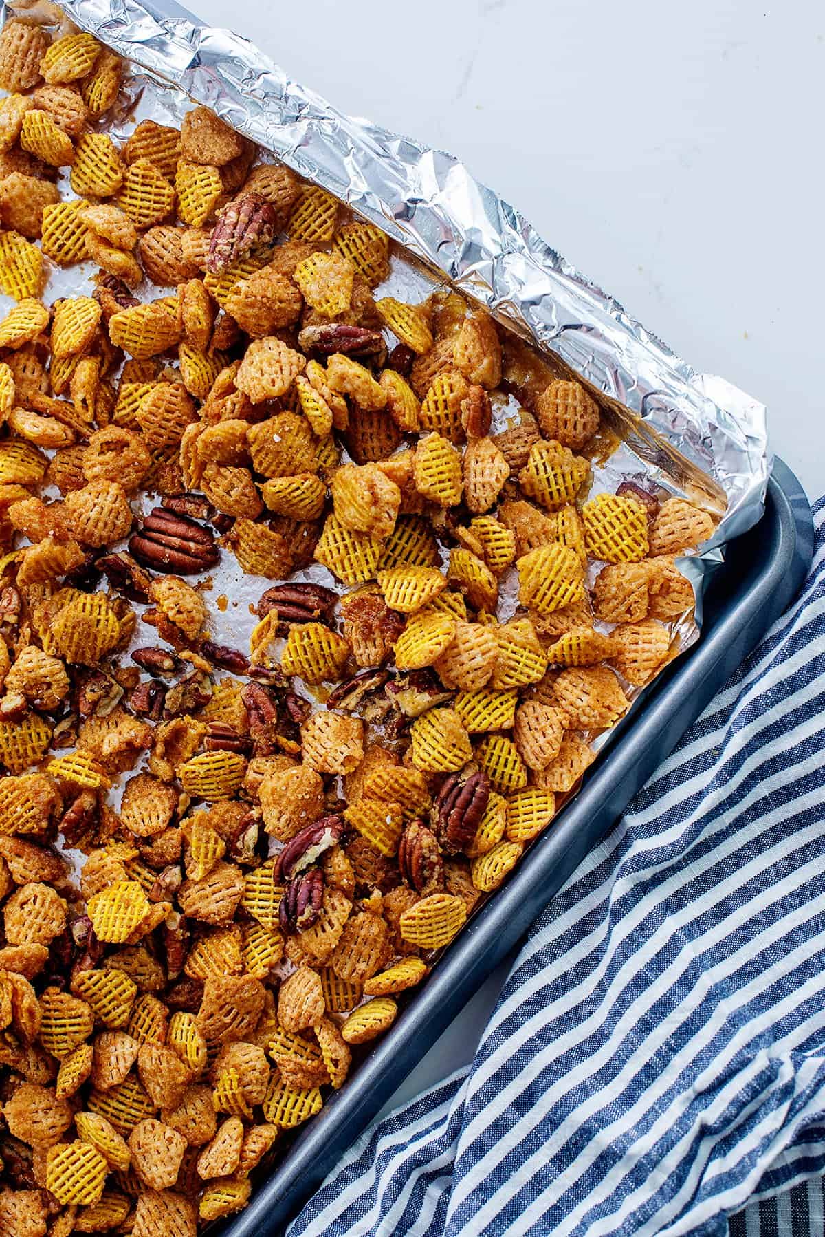 praline snack mix on baking sheet.