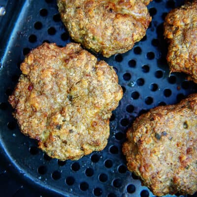 turkey burgers in air fryer basket.