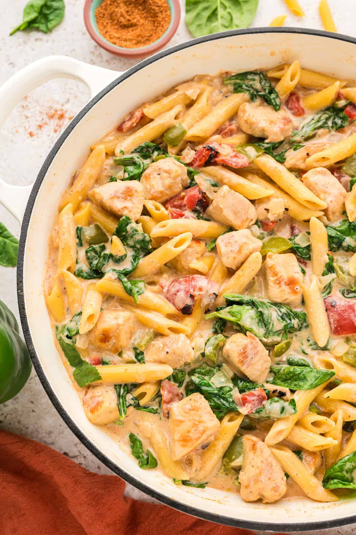 Pot full of chicken and spinach pasta.