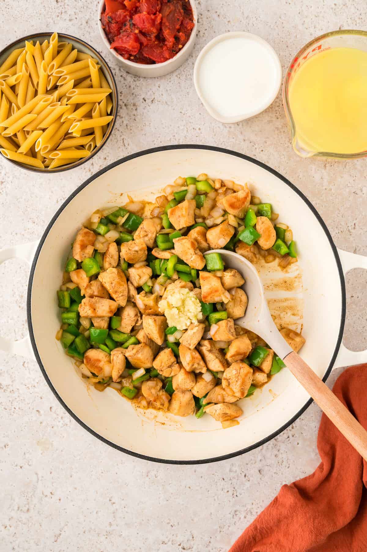 Chicken, peppers, and onions in skillet.