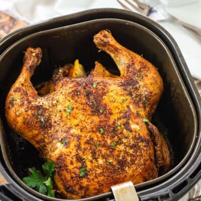 roasted chicken in air fryer basket.