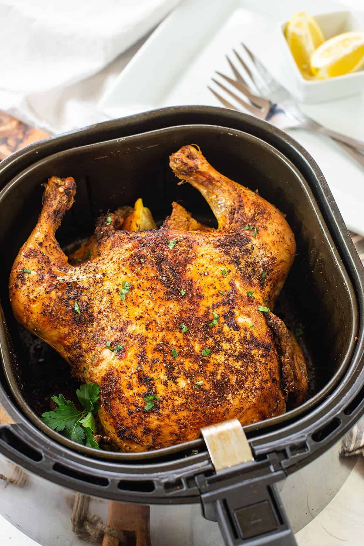 roasted chicken in air fryer basket.