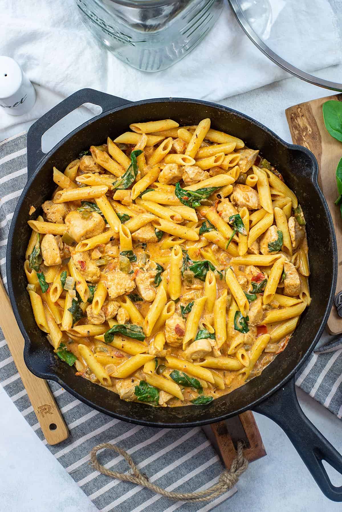 creamy Cajun chicken pasta in skillet.