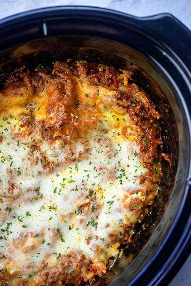Freshly made lasagna in a slow cooker.