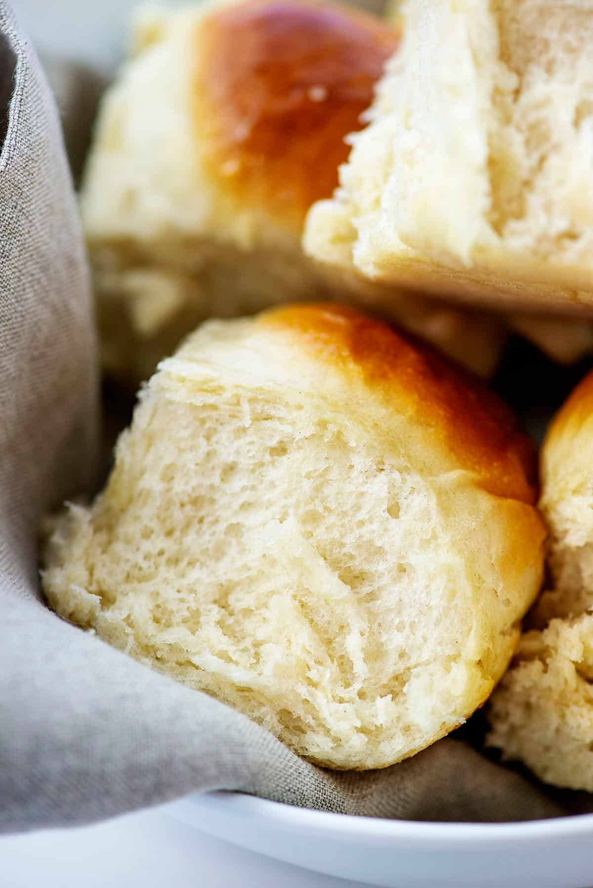 fluffy dinner rolls in basket.