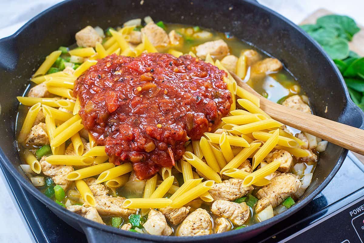 pasta and tomatoes in skillet.