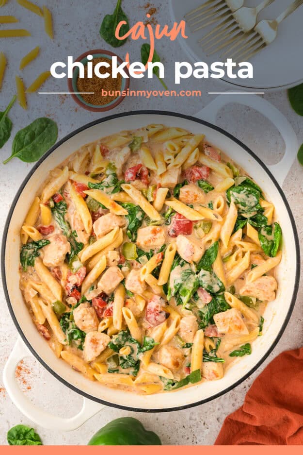 Cajun chicken and spinach pasta in white pot.