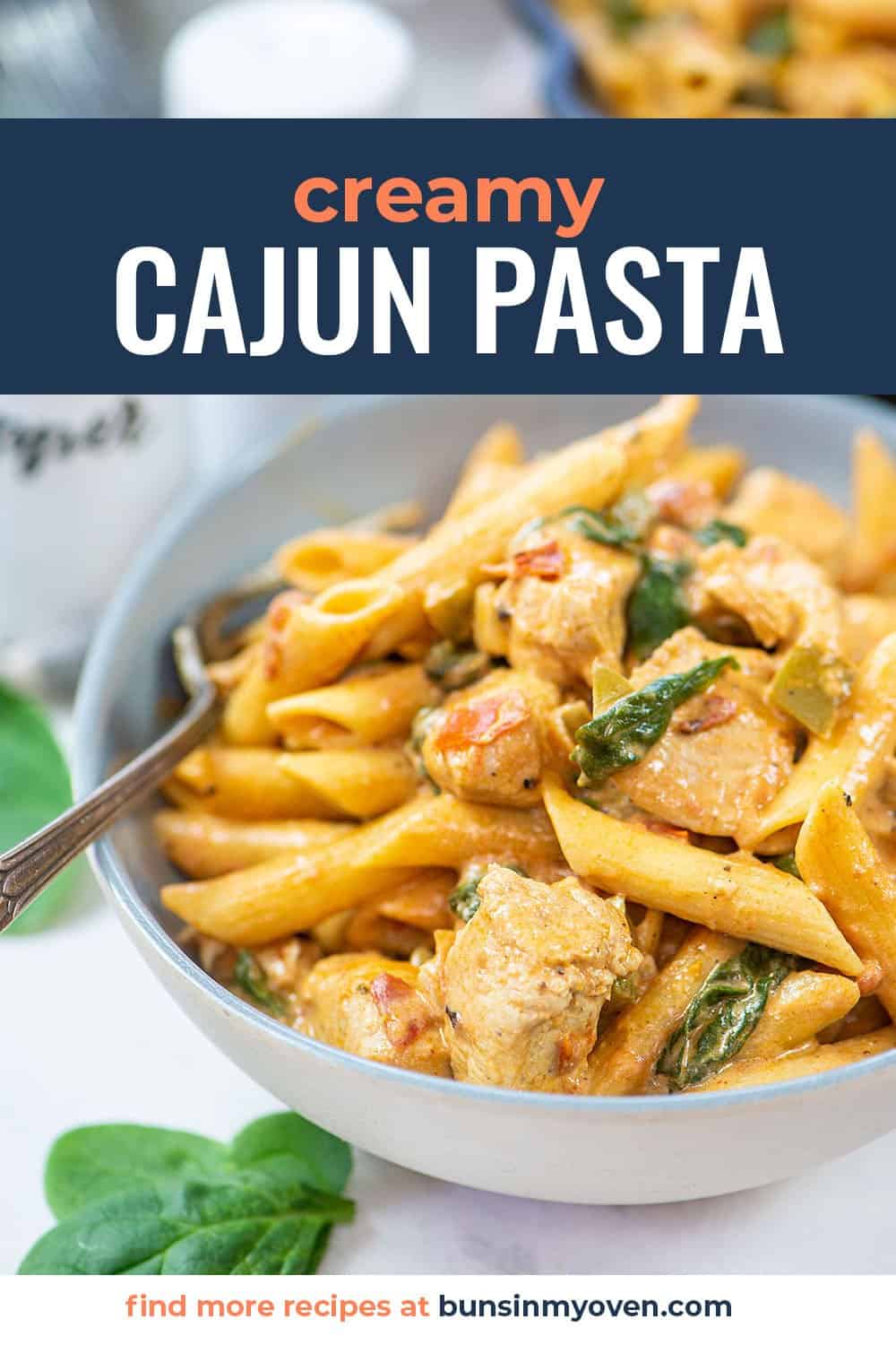 creamy Cajun pasta in bowl with text for Pinterest.