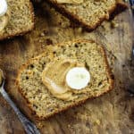 Sliced banana bread spread with peanut butter.