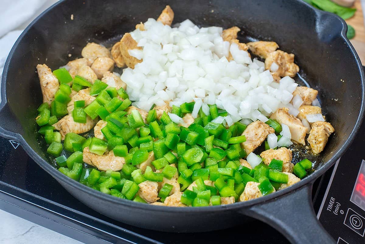 chicken and veggies in skillet.