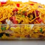 cornrbead salad layered in baking dsih.