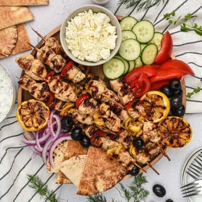 Greek chicken kabob platter with vegetables and pita.