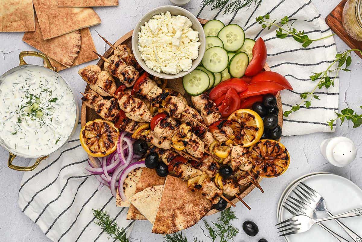 Greek chicken kabob platter with vegetables and pita.