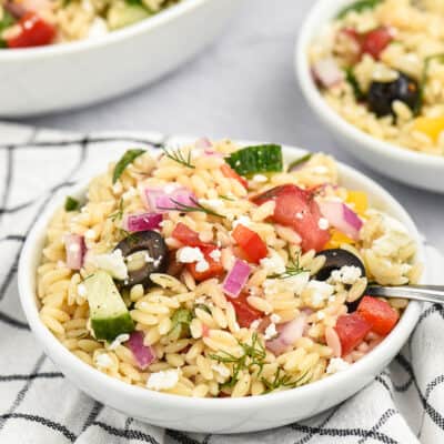 orzo salad in small white bowls.