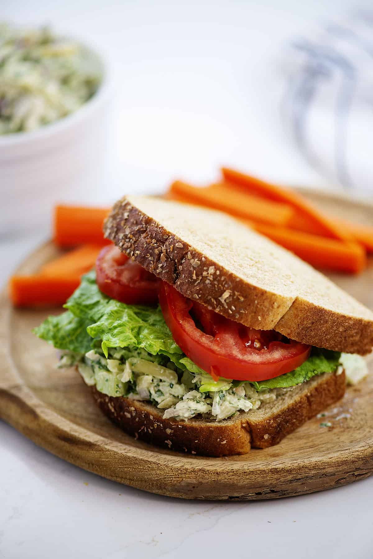 Green goddess chicken salad between two slices of bread.