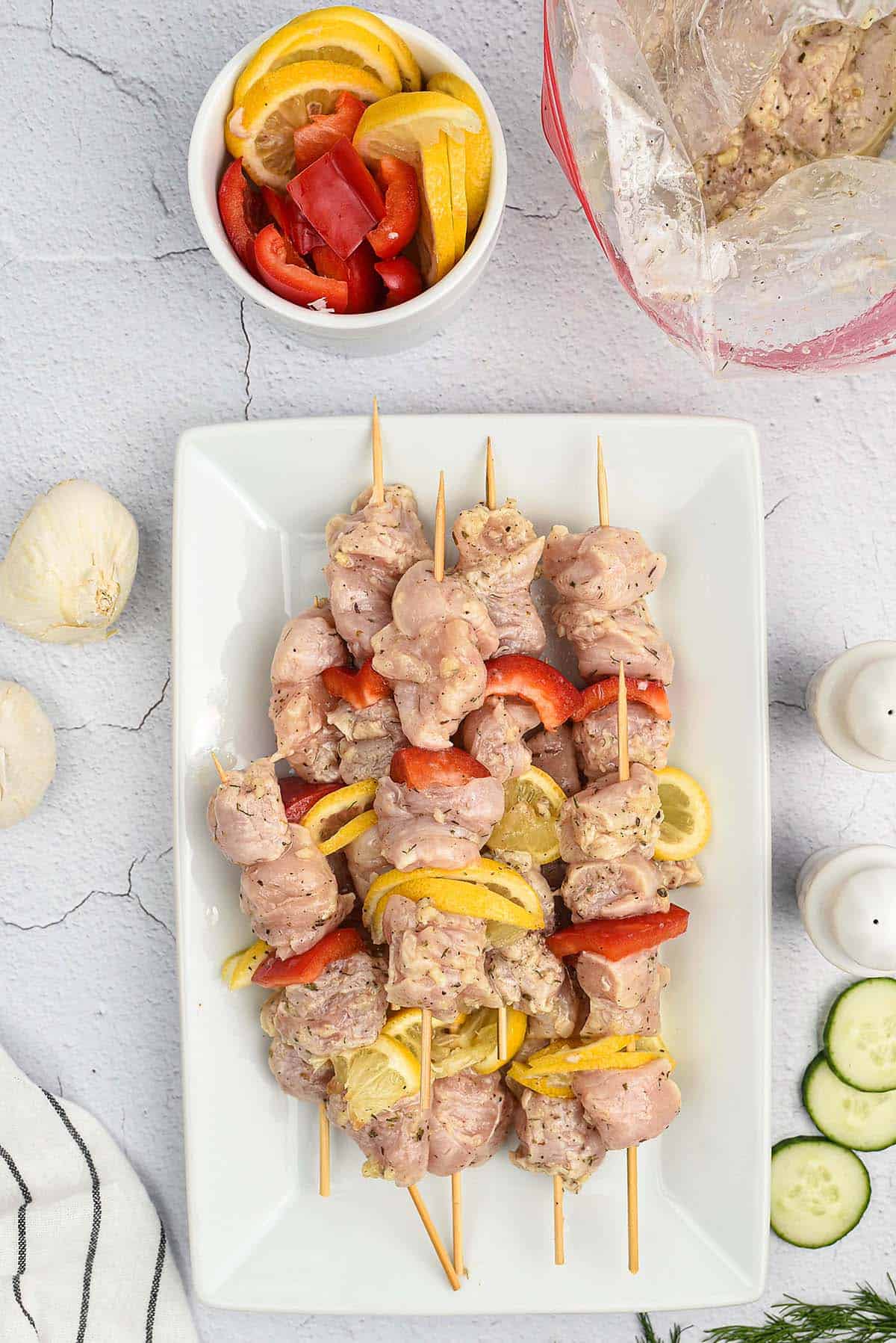 chicken and peppers on wooden skewers for grilling.