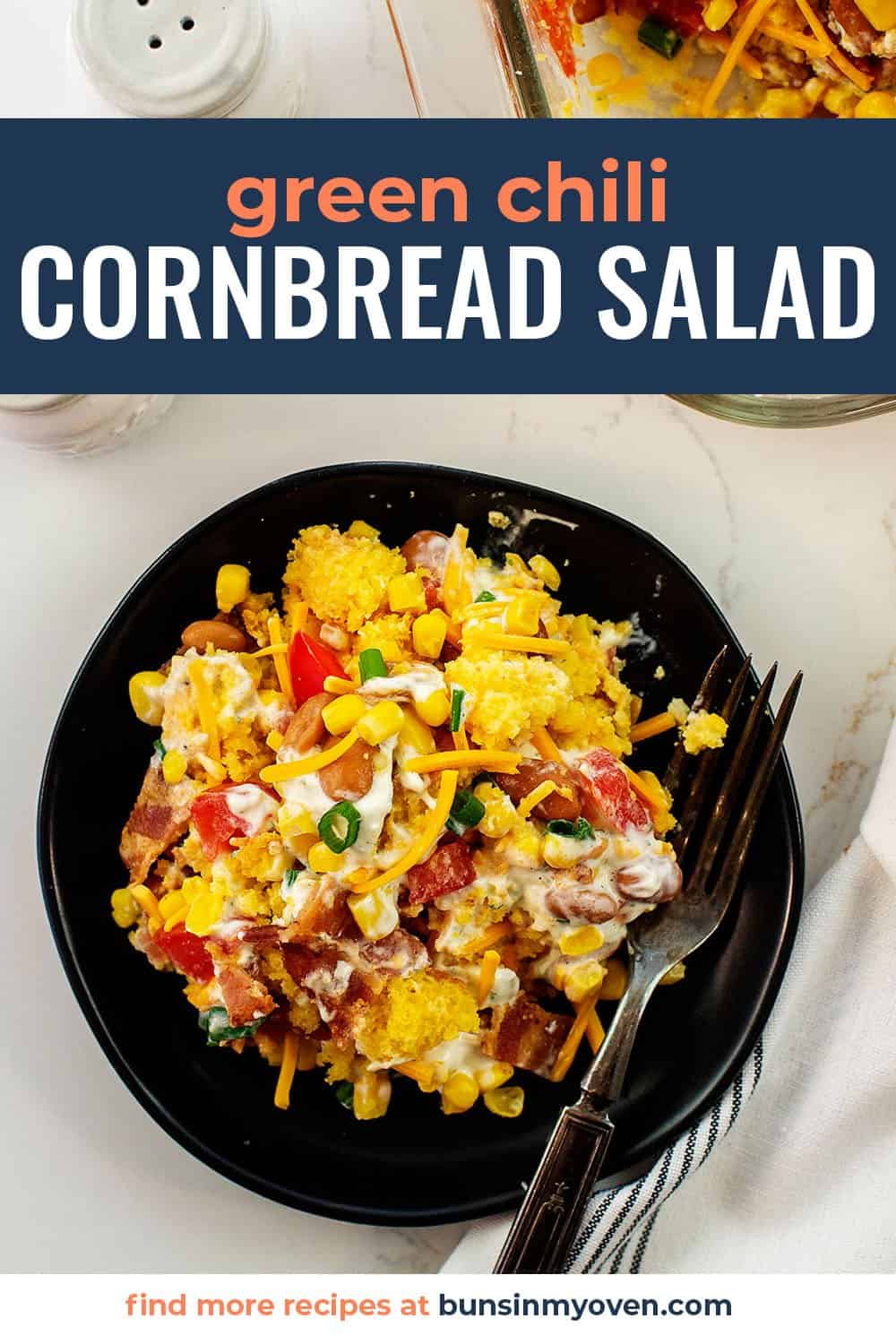 green chile cornbread salad on black plate.