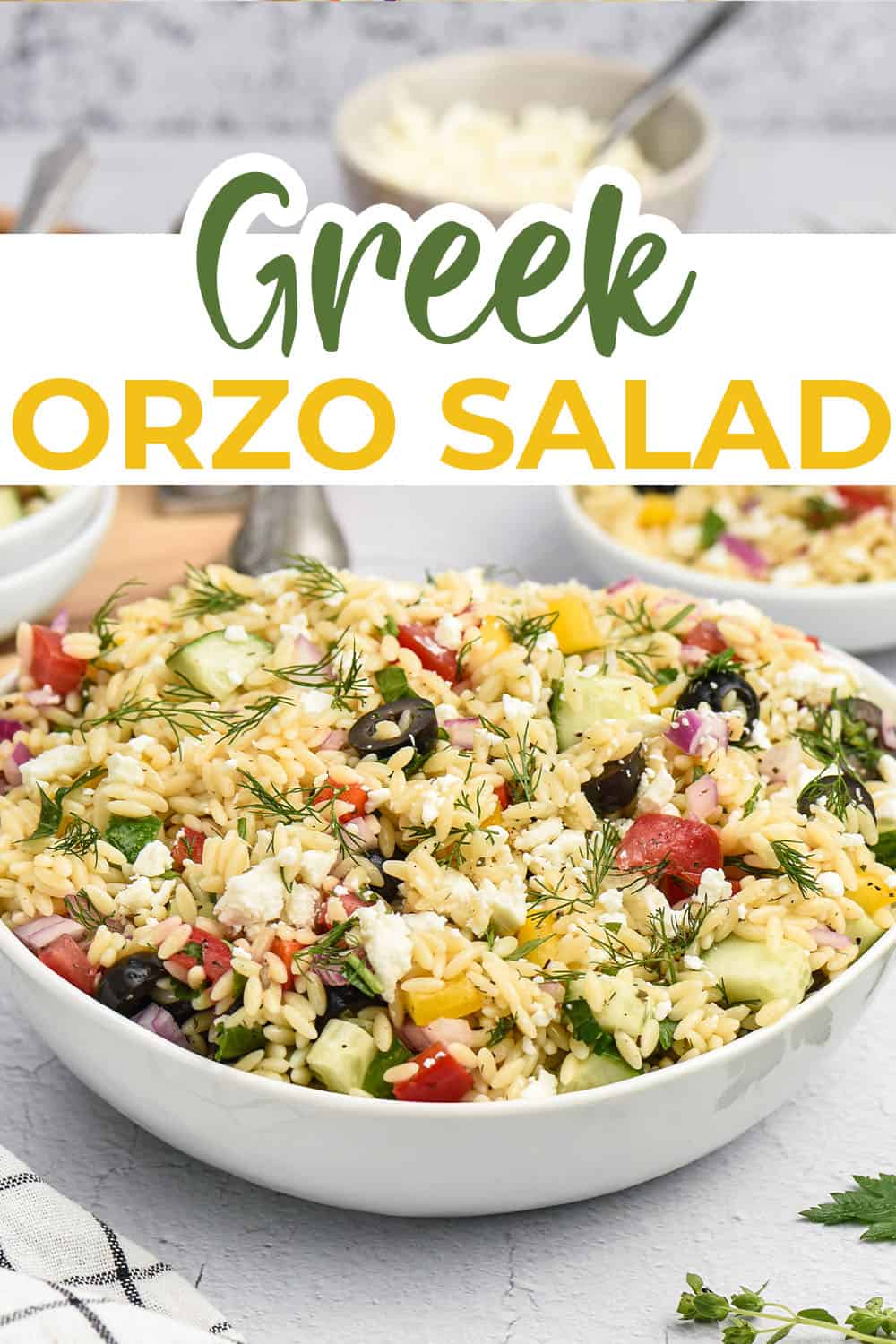 Greek orzo salad in white bowl.