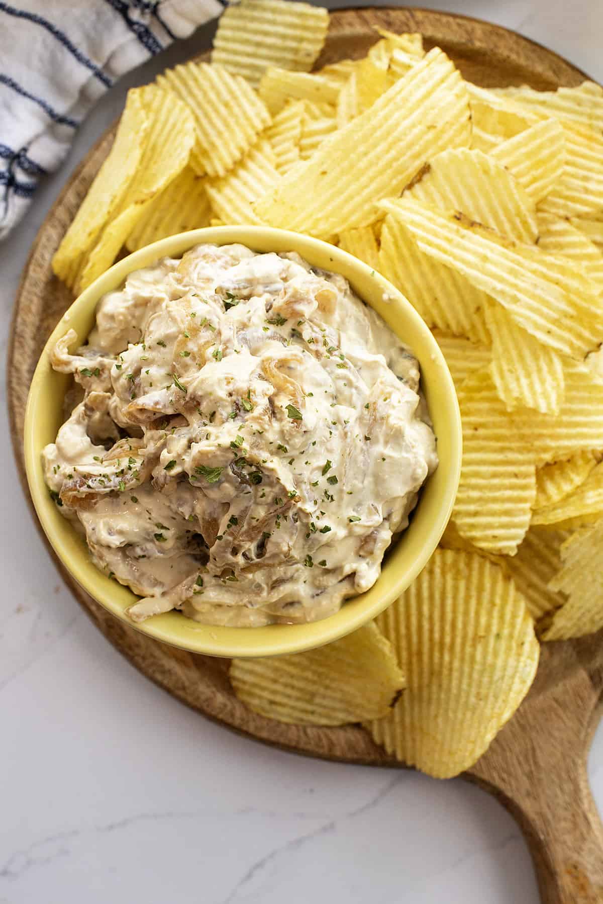 overhead view of caramelized onion dip surrounded by chips.