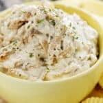 homemade caramelized onion dip in small yellow bowl.