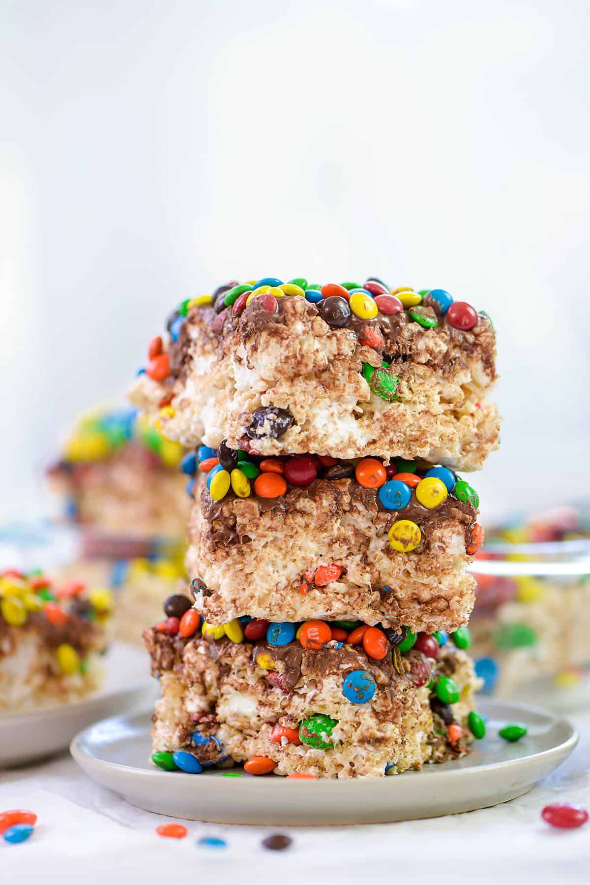 m&m rice krispies treats stacked on plate.