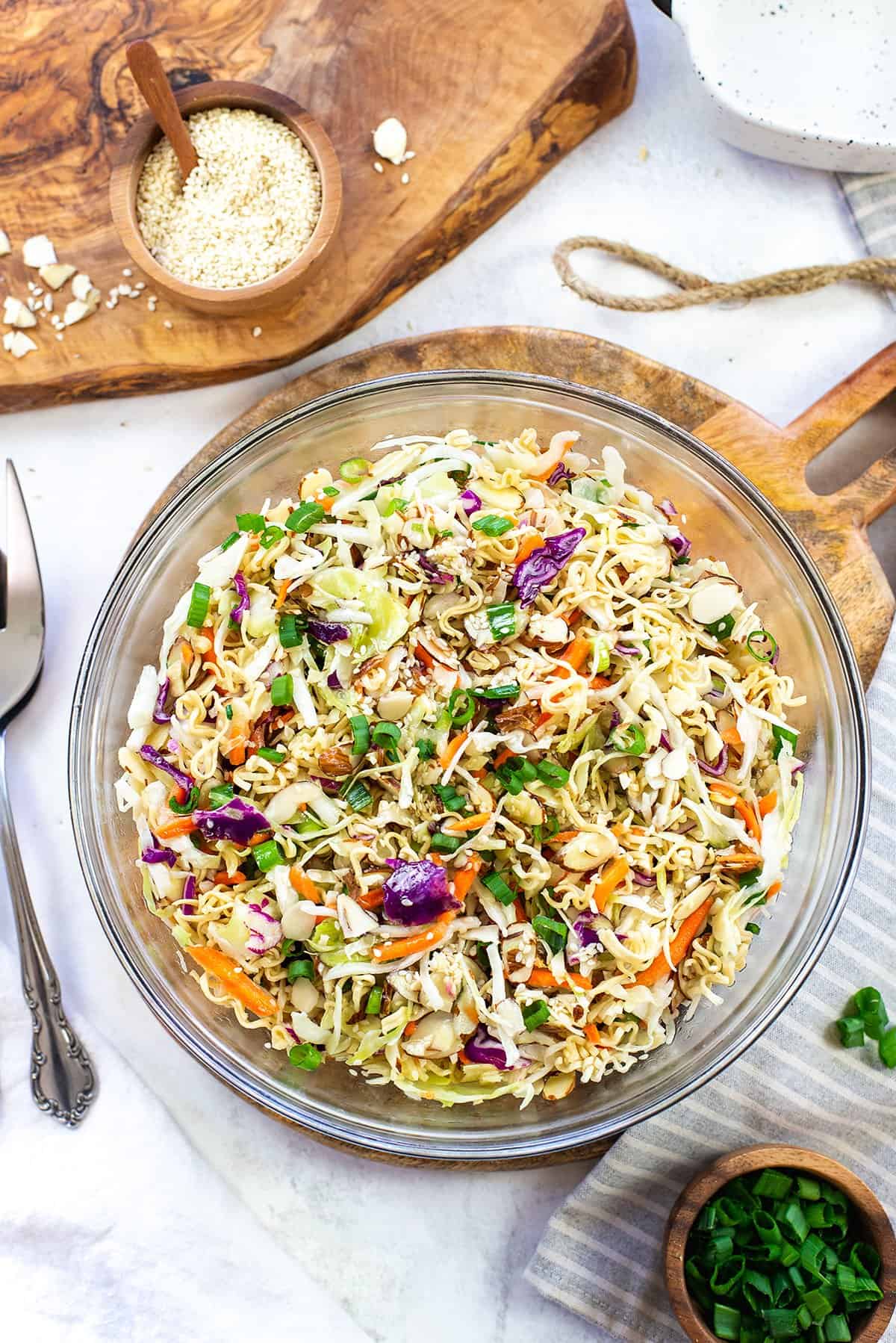 big glass bowl full of Asian ramen salad.