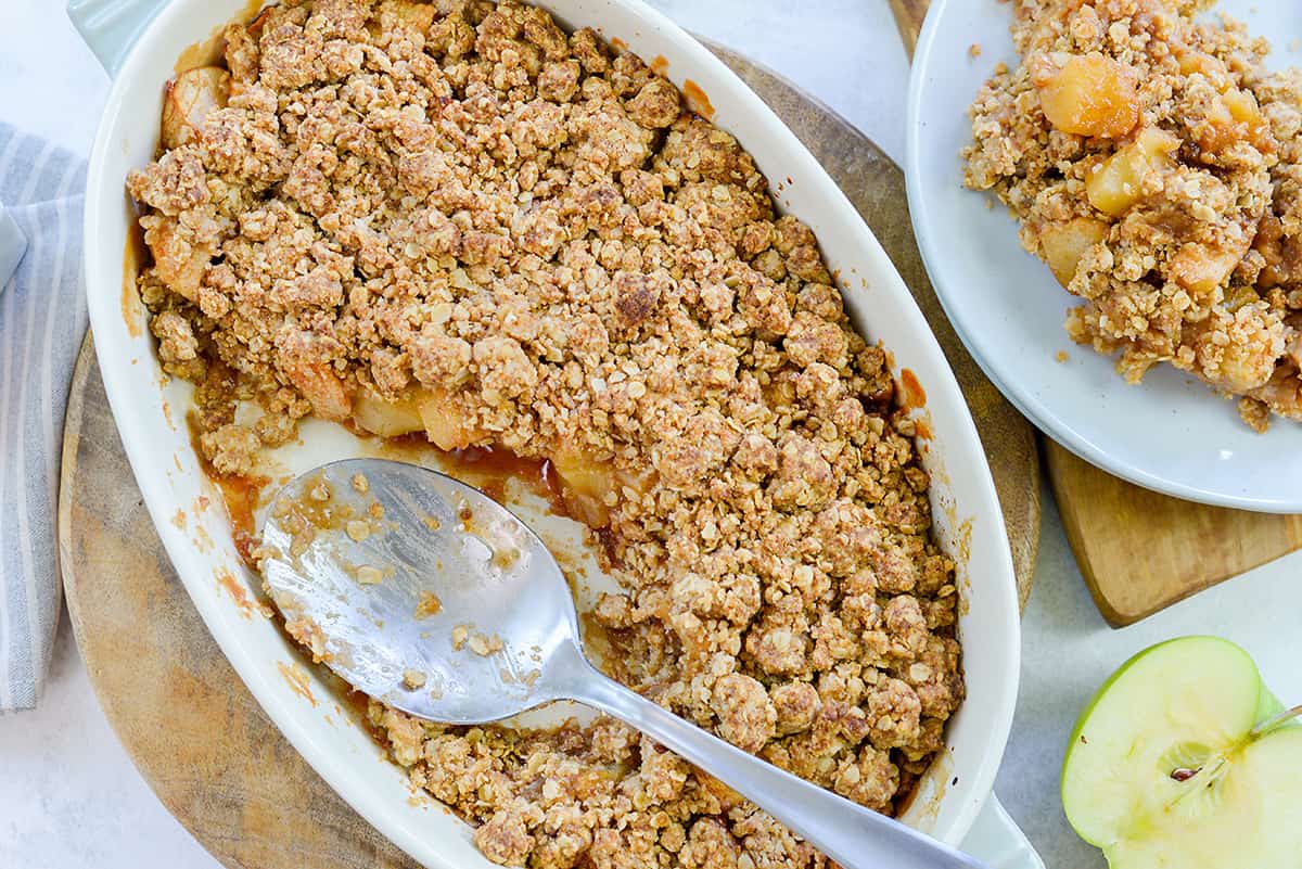 baked apple crumble in white dish.