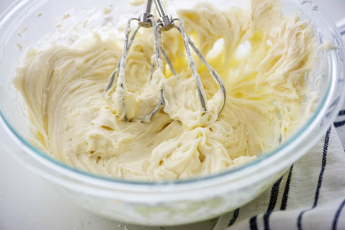 cream cheese frosting in glass mixing bowl.