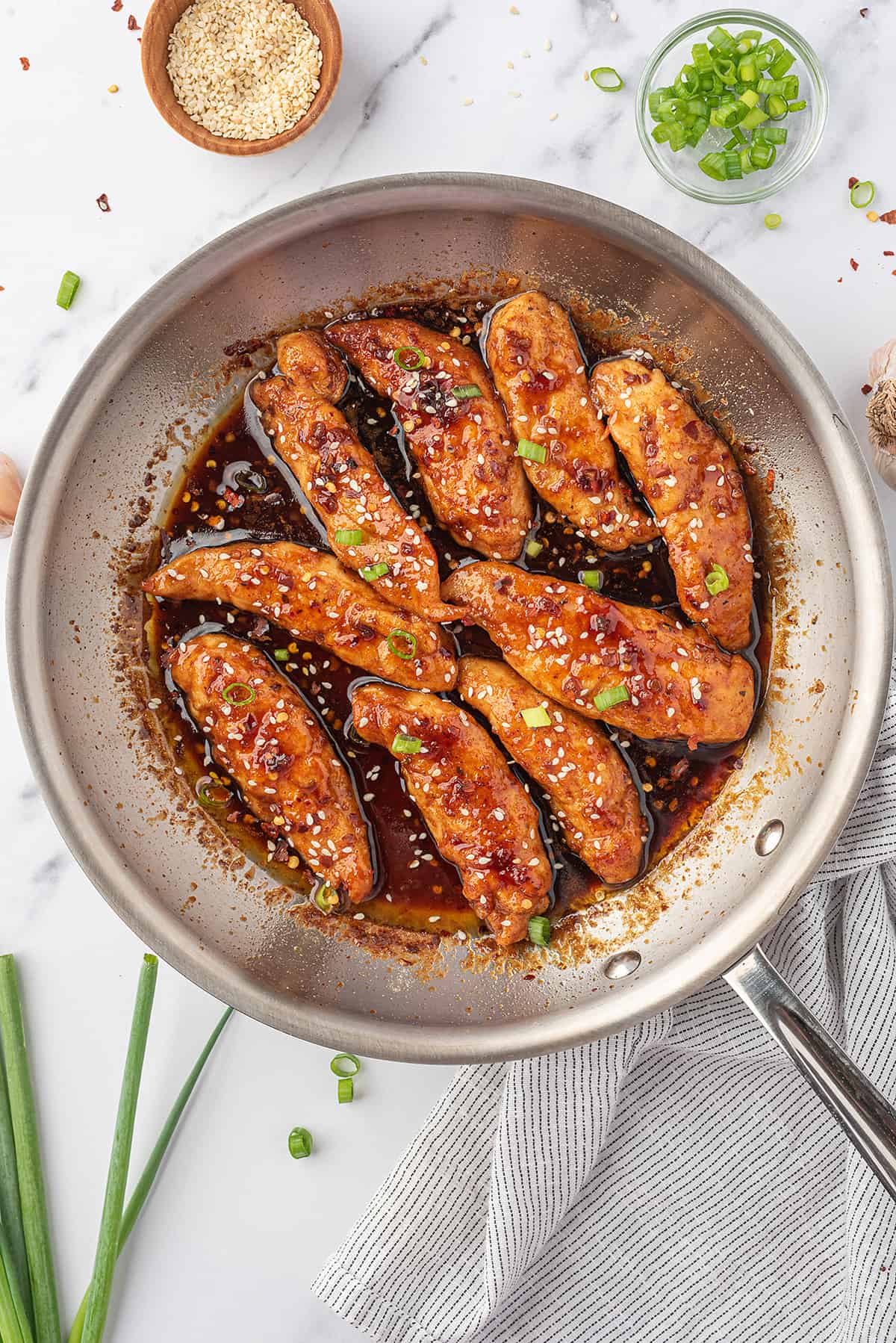 Honey garlic chicken tenders in skillet.