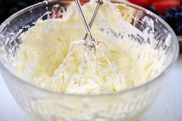 fruit dip in mixing bowl with electric mixer blades.