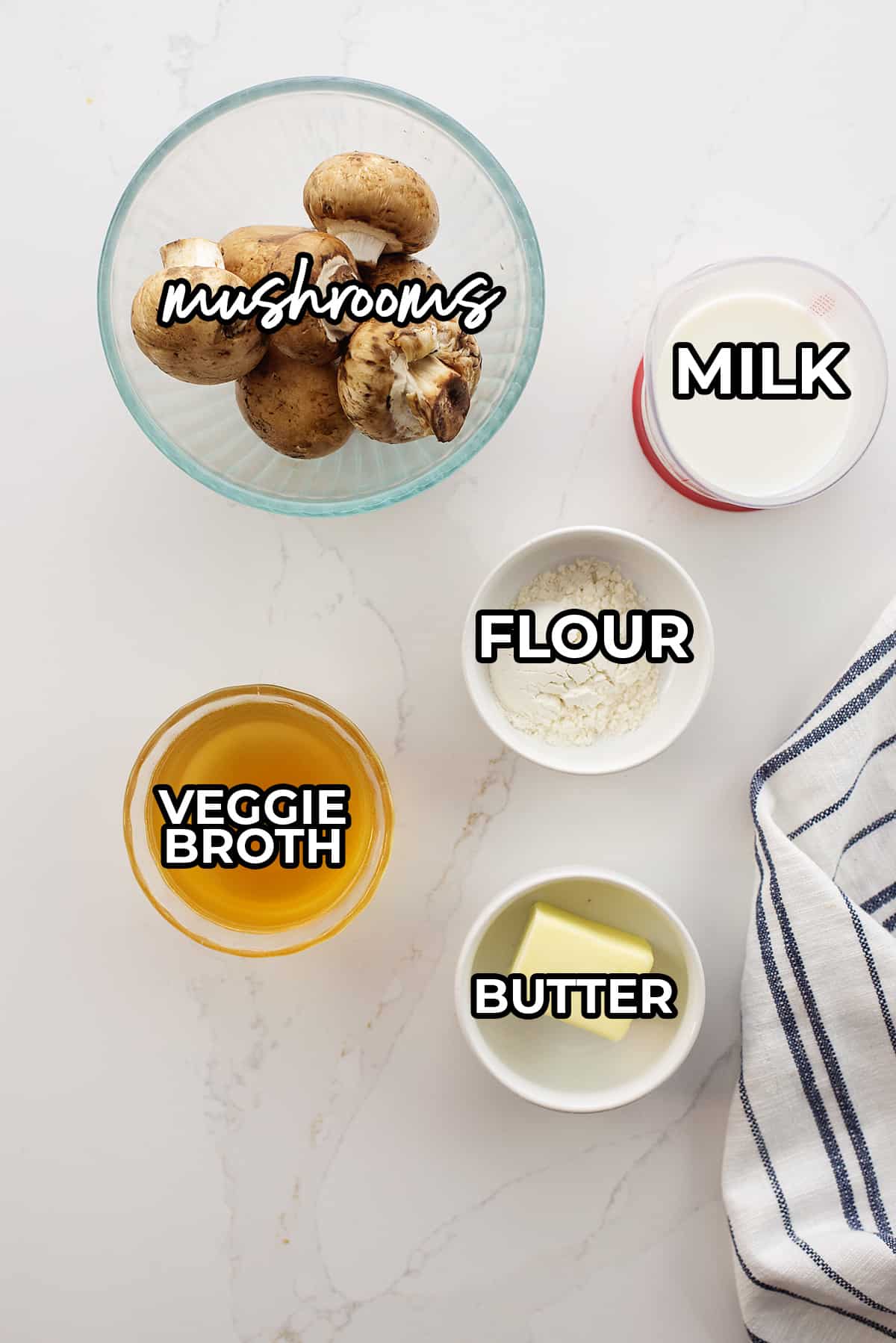 Ingredients for cream of mushroom soup recipe laid on counter.