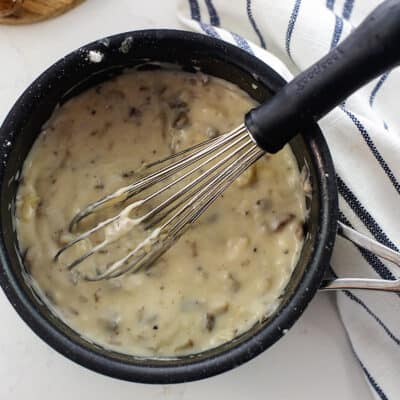 cream of mushroom soup in black sauce pan.