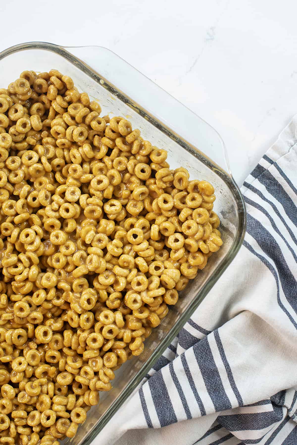 peanut butter cheerio bars in glass baking dish.