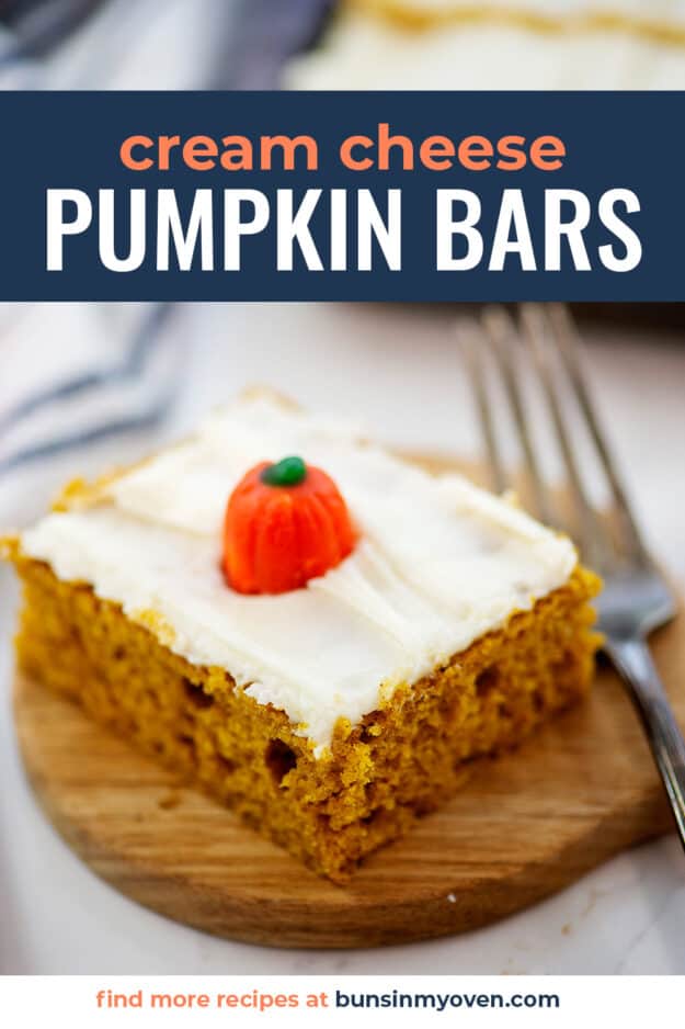 pumpkin bars topped with cream cheese frosting and pumpkin candy.