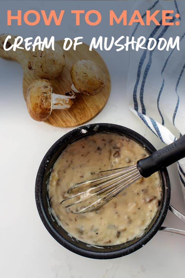 Overhead view of cream of mushroom soup in black sauce pan.