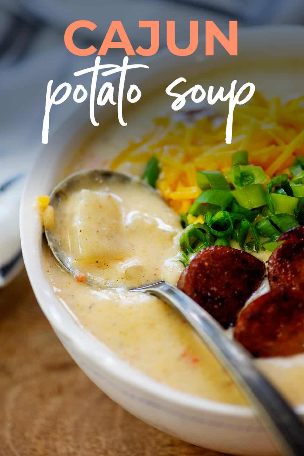 Potato soup in bowl with spoon.