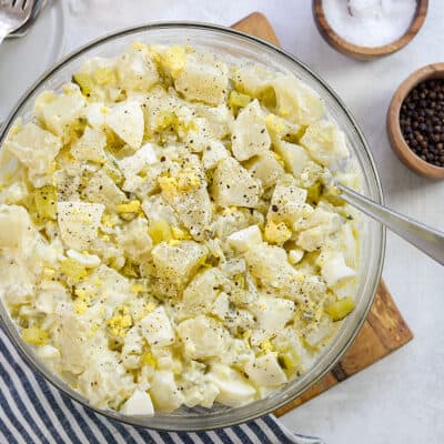 overhead view of potato salad in glass bowl.