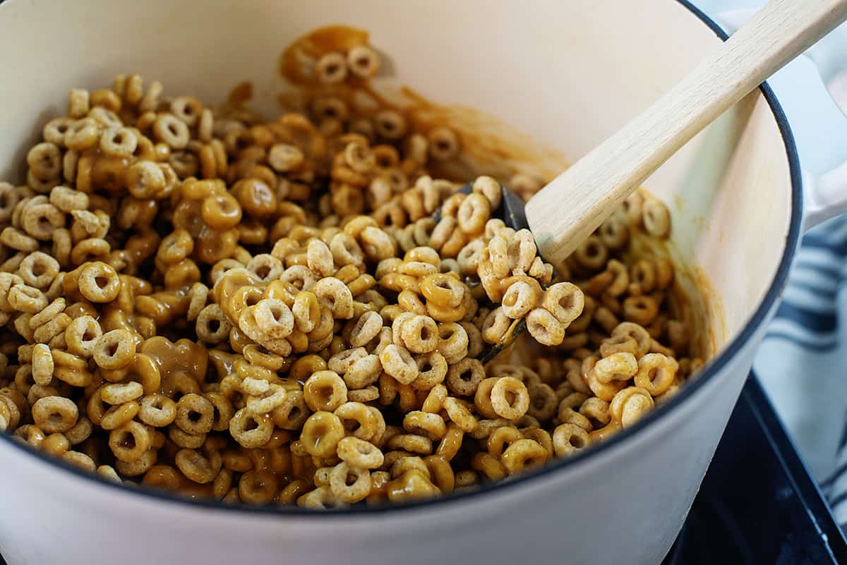 peanut butter, cheerios, and honey in pot.