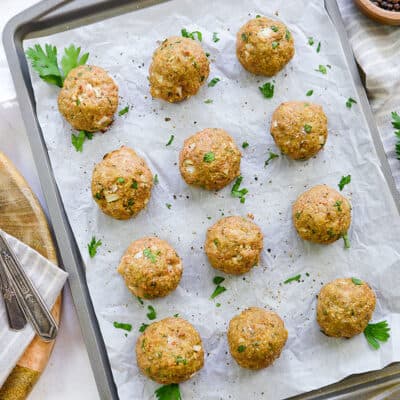 overhead view of healthy turkey meatballs on baking sheet.