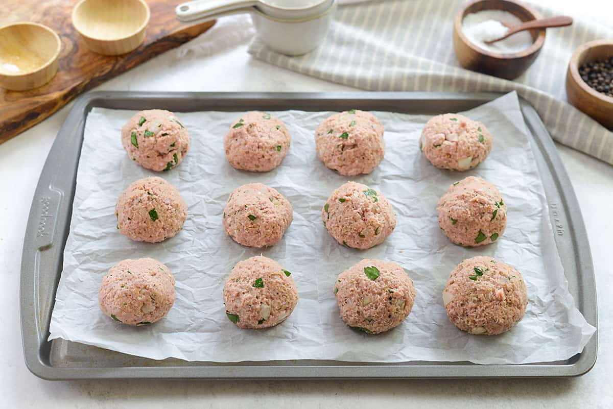 raw turkey meatballs on baking sheet.