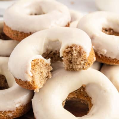 maple glazed baked donuts piled together.