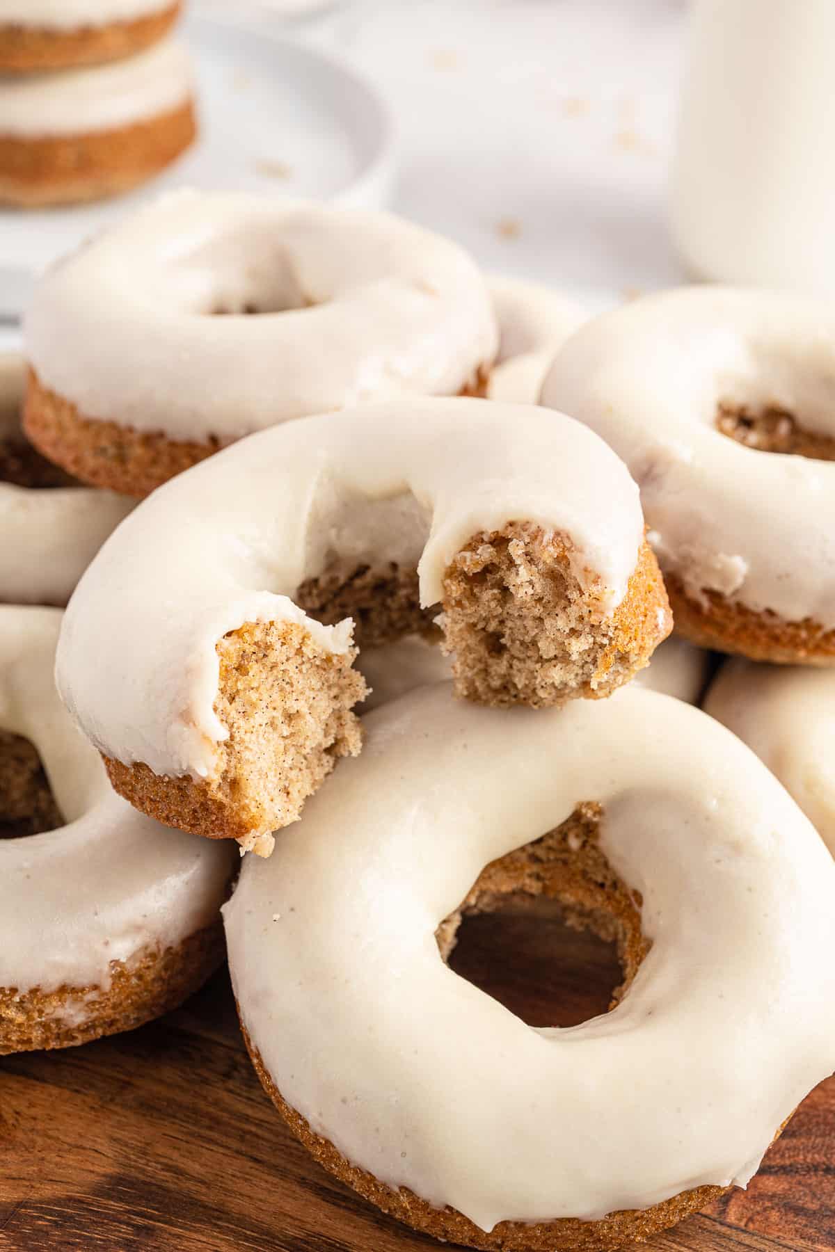 maple glazed baked donuts piled together.