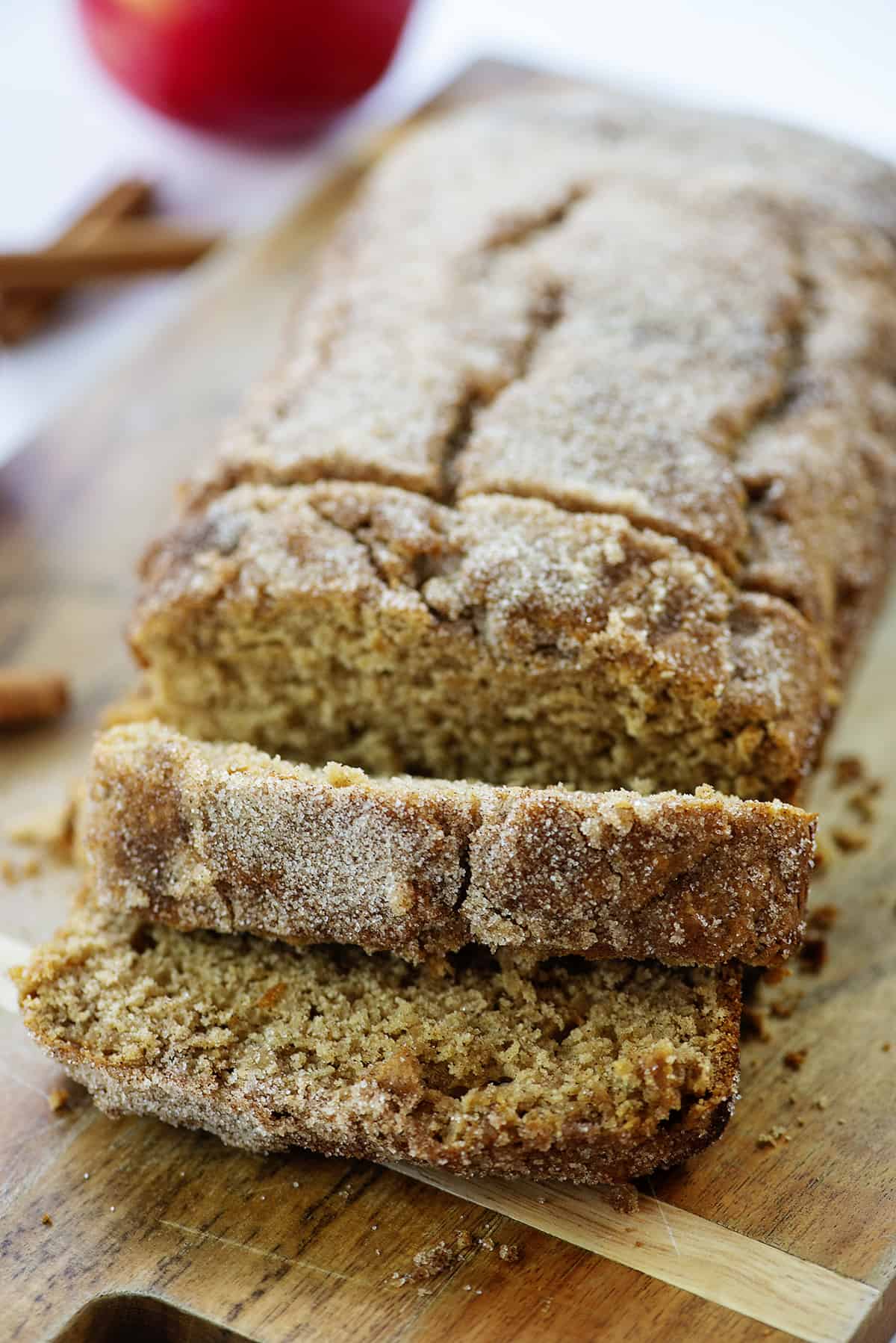 apple cider donut bread sliced on wooden board.