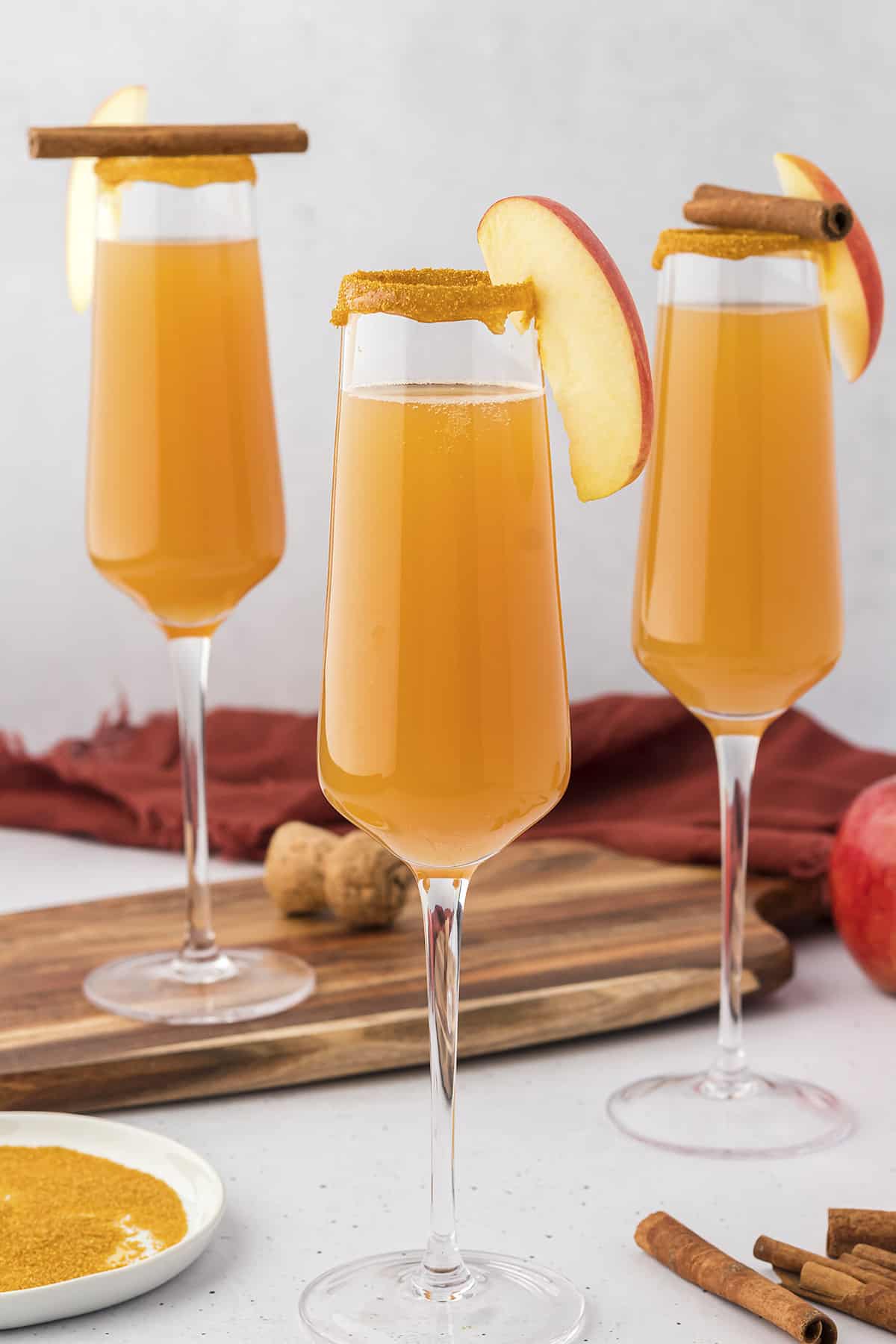 Apple cider mimosa in champagne flutes.