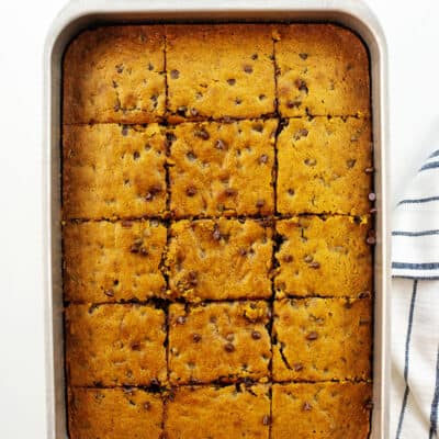 sliced pumpkin cake in metal pan.