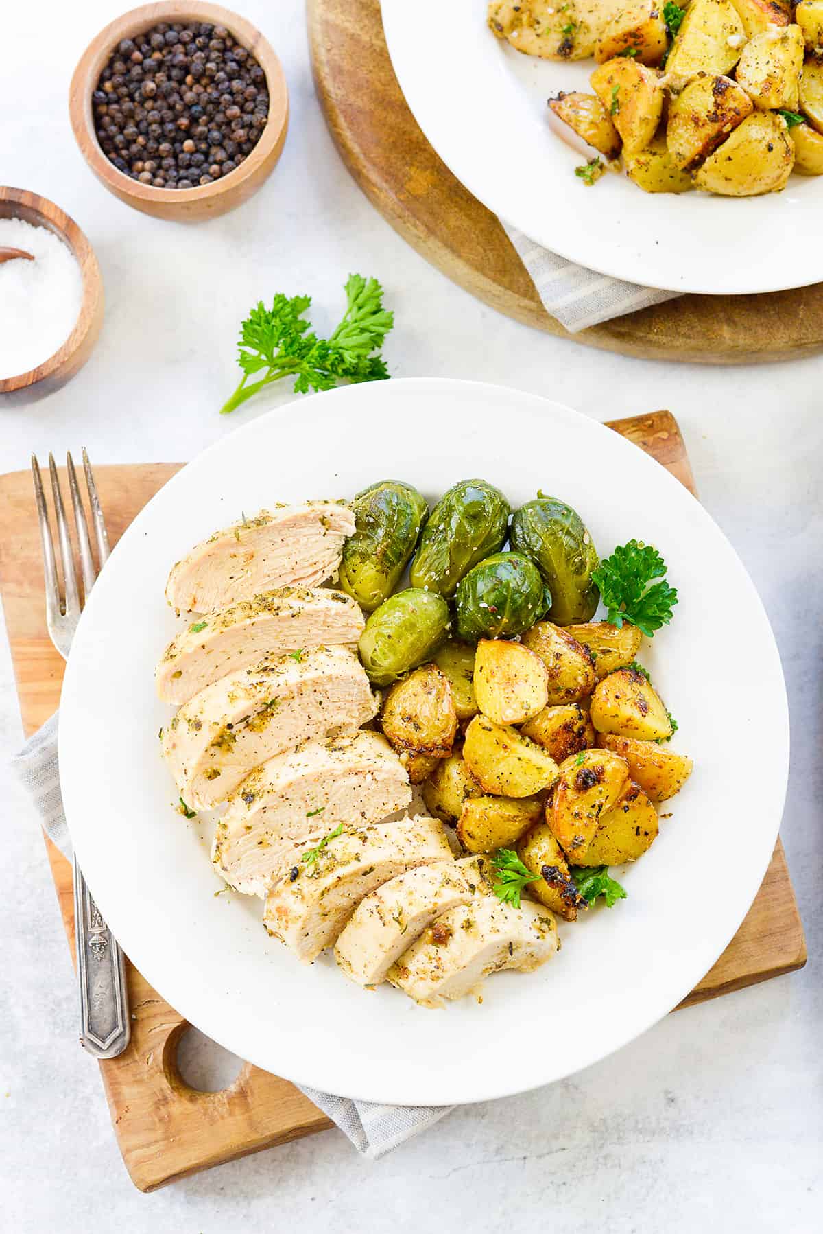 plate of sliced chicken, potatoes, and Brussels sprouts.